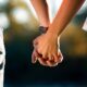 A couple holding hands scaled 1